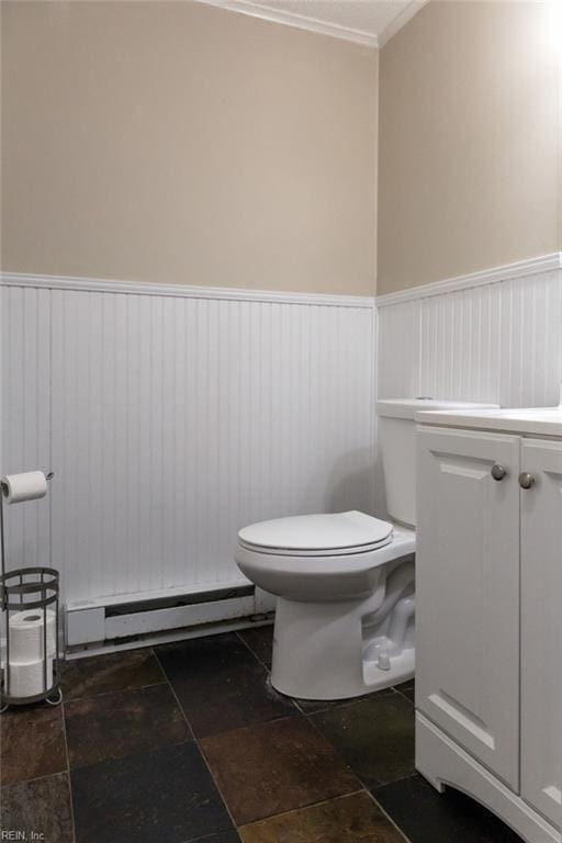 125 Messick Rd, Poquoson, VA 23662 - half bathroom featuring baseboard heating, toilet, a wainscoted wall, ornamental molding, and stone finish floors