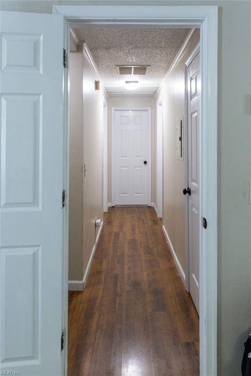 125 Messick Rd, Poquoson, VA 23662 - hall featuring dark wood-style flooring, baseboards, and a textured ceiling