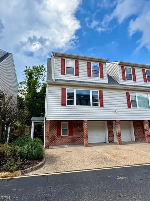8550 Tidewater Dr Unit C1, Norfolk, VA 23503 - view of front of property featuring brick siding, an attached garage, and driveway