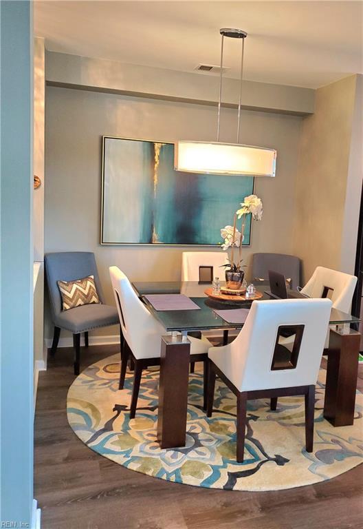 dining space with wood finished floors