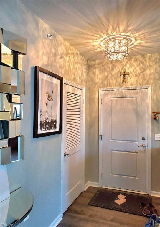 entryway featuring dark wood-style flooring and baseboards