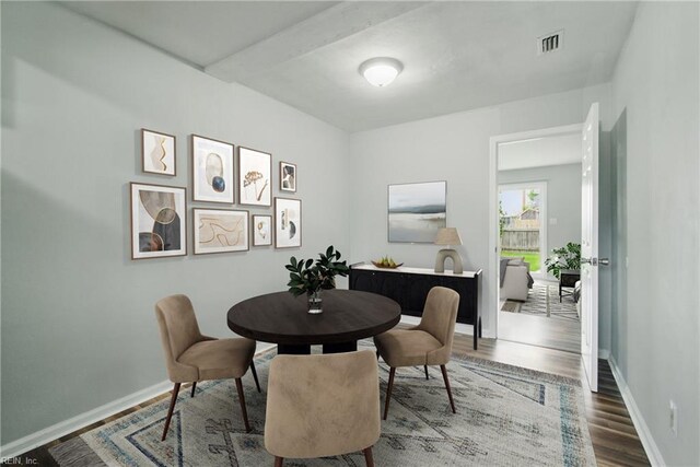 dining space featuring wood finished floors and baseboards