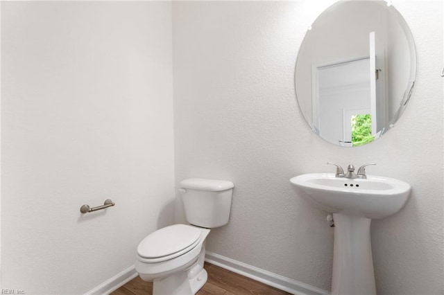 3127 Lens Ave, Norfolk, VA 23509 - half bath featuring wood finished floors, baseboards, toilet, and a sink