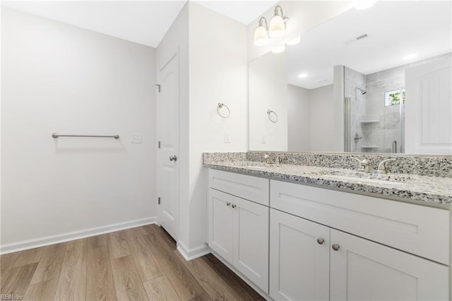 3127 Lens Ave, Norfolk, VA 23509 - bathroom featuring a stall shower, wood finished floors, double vanity, and baseboards