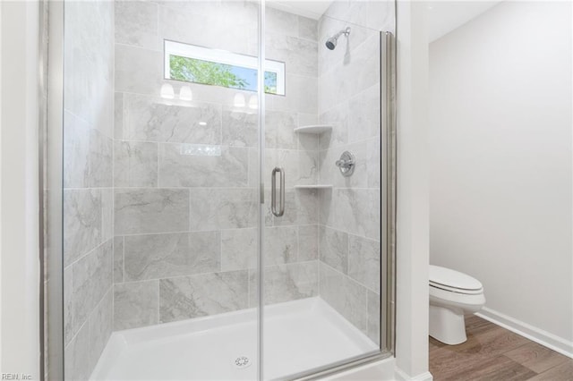 3127 Lens Ave, Norfolk, VA 23509 - bathroom with wood finished floors, toilet, a stall shower, and baseboards