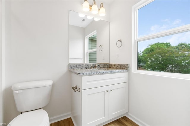 3127 Lens Ave, Norfolk, VA 23509 - bathroom with wood finished floors, baseboards, toilet, and vanity