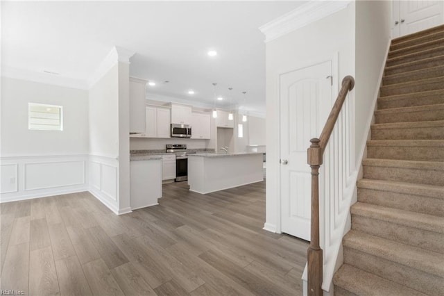 3127 Lens Ave, Norfolk, VA 23509 - kitchen with stainless steel appliances, crown molding, light wood-type flooring, white cabinets, and recessed lighting
