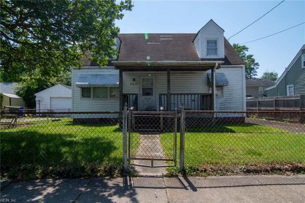 back of house with a porch, a detached garage, and a gate
