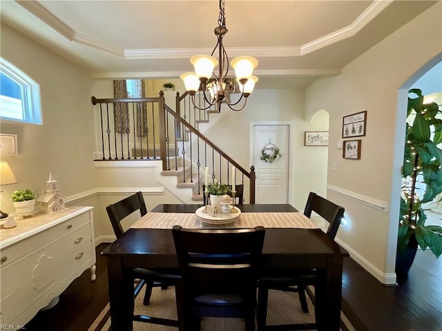 dining area featuring arched walkways, a chandelier, ornamental molding, dark wood-type flooring, and stairway