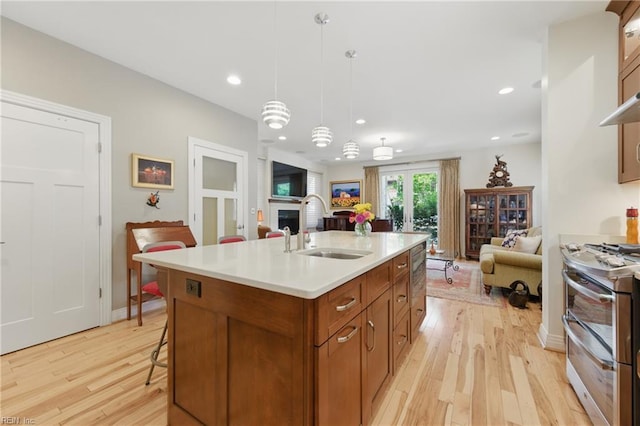 726 Redgate Ave, Norfolk, VA 23507 - kitchen featuring a sink, double oven range, open floor plan, brown cabinetry, and recessed lighting