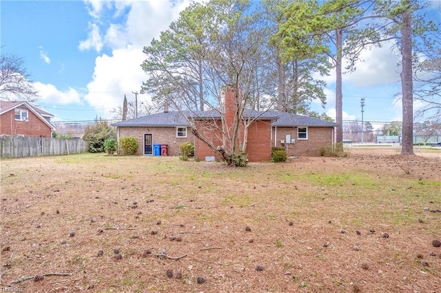 837 Mount Pleasant Rd, Chesapeake, VA 23322 - rear view of property with fence, brick siding, and a chimney