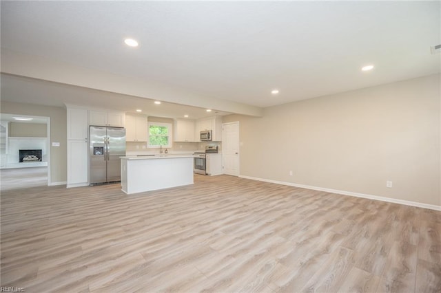 837 Mount Pleasant Rd, Chesapeake, VA 23322 - unfurnished living room featuring recessed lighting, baseboards, light wood finished floors, and a fireplace