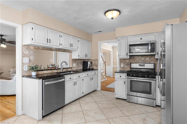 2124 Thackeray Ln, Virginia Beach, VA 23454 - kitchen featuring appliances with stainless steel finishes, a sink, dark countertops, and decorative backsplash