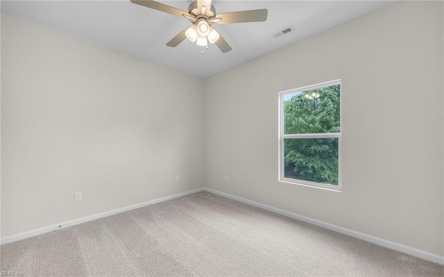 empty room with baseboards, carpet flooring, and a ceiling fan