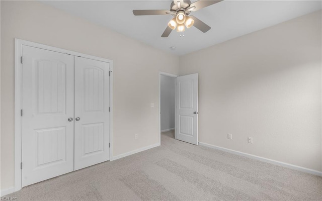 unfurnished bedroom featuring carpet flooring, baseboards, a closet, and a ceiling fan