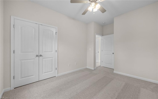 unfurnished bedroom with carpet flooring, a closet, baseboards, and ceiling fan