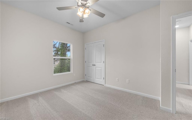 unfurnished bedroom with carpet flooring, baseboards, and a ceiling fan