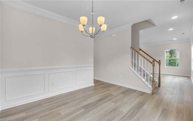 unfurnished dining area with ornamental molding, light wood-style floors, a chandelier, stairway, and recessed lighting