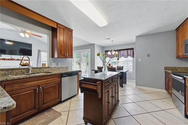 6701 Burbage Landing Cir, Suffolk, VA 23435 - kitchen with appliances with stainless steel finishes, a sink, dark stone counters, ceiling fan, and light tile patterned flooring