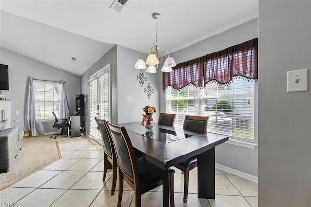6701 Burbage Landing Cir, Suffolk, VA 23435 - dining area with a chandelier, light tile patterned floors, vaulted ceiling, and baseboards