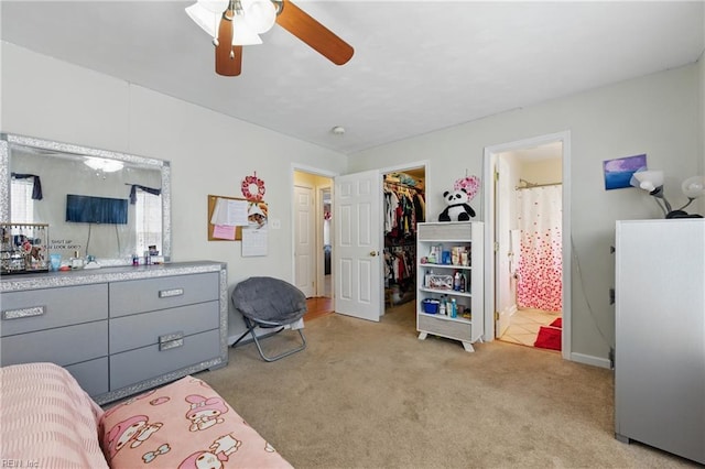 6701 Burbage Landing Cir, Suffolk, VA 23435 - bedroom with light carpet, a walk in closet, a closet, a ceiling fan, and ensuite bath