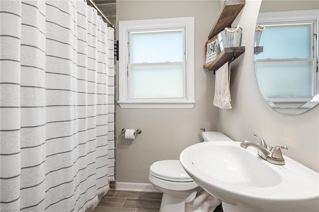 504 Amster Ln, Chesapeake, VA 23323 - bathroom featuring toilet, a sink, baseboards, wood tiled floors, and curtained shower