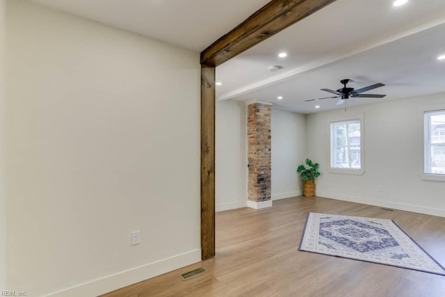 1413 Elm Ave, Portsmouth, VA 23704 - empty room with decorative columns, beamed ceiling, baseboards, light wood finished floors, and ceiling fan