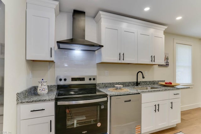 1413 Elm Ave, Portsmouth, VA 23704 - kitchen with wall chimney exhaust hood, stainless steel appliances, a sink, white cabinets, and light wood finished floors