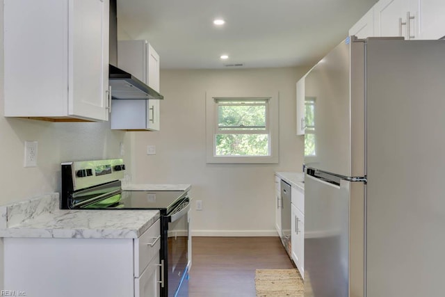 1413 Elm Ave, Portsmouth, VA 23704 - kitchen with stainless steel appliances, wall chimney exhaust hood, dark wood-style floors, white cabinets, and light countertops