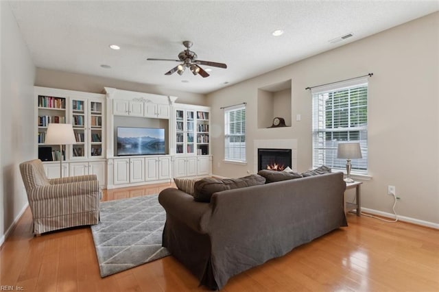 218 Woodburne Ln, Newport News, VA 23602 - living room featuring baseboards, a tile fireplace, light wood-style flooring, ceiling fan, and recessed lighting