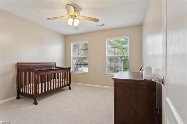 218 Woodburne Ln, Newport News, VA 23602 - bedroom featuring light carpet, baseboards, a nursery area, and a textured ceiling