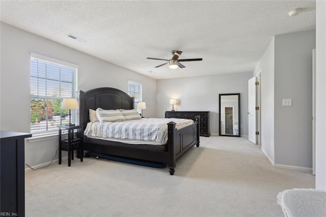 218 Woodburne Ln, Newport News, VA 23602 - bedroom featuring light carpet, multiple windows, baseboards, and a textured ceiling