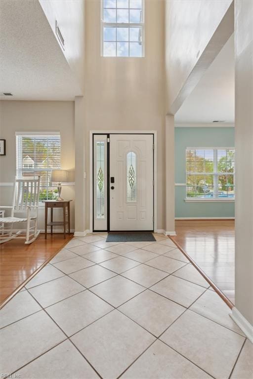 218 Woodburne Ln, Newport News, VA 23602 - tiled foyer featuring a towering ceiling, healthy amount of natural light, and baseboards
