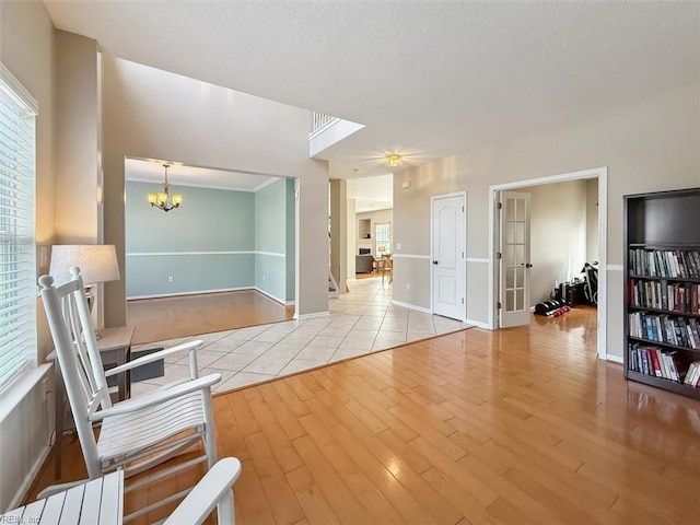 218 Woodburne Ln, Newport News, VA 23602 - unfurnished room with wood finished floors, a chandelier, a textured ceiling, and baseboards
