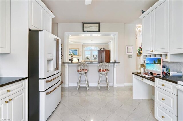 433 Croatan Rd, Virginia Beach, VA 23451 - kitchen featuring high end white refrigerator, dark countertops, white cabinets, and decorative backsplash