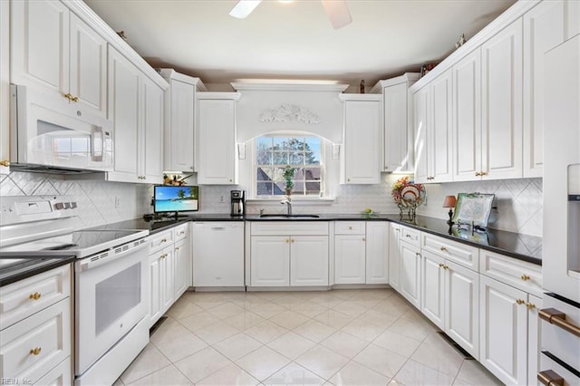 433 Croatan Rd, Virginia Beach, VA 23451 - kitchen featuring white appliances, dark countertops, a sink, ceiling fan, and white cabinetry