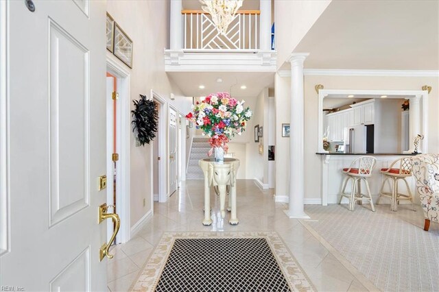 433 Croatan Rd, Virginia Beach, VA 23451 - entrance foyer with ornate columns, ornamental molding, baseboards, a chandelier, and a towering ceiling