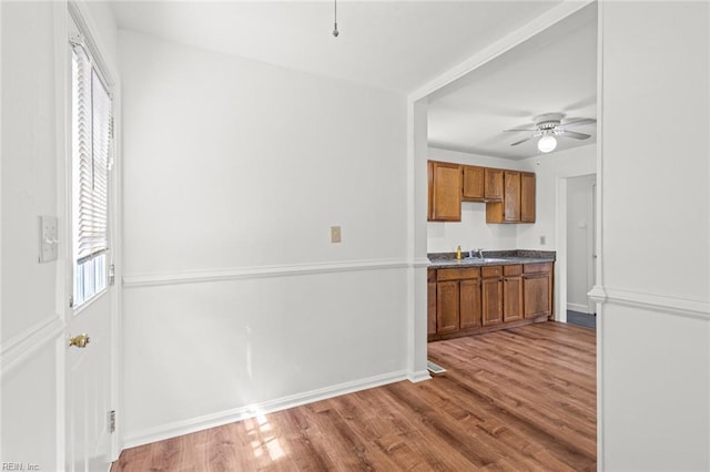 16 Warner Rd, Hampton, VA 23666 - kitchen with brown cabinetry, a sink, ceiling fan, and wood finished floors