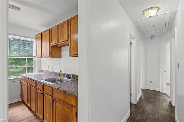 16 Warner Rd, Hampton, VA 23666 - kitchen with a sink, dark wood finished floors, brown cabinetry, and baseboards