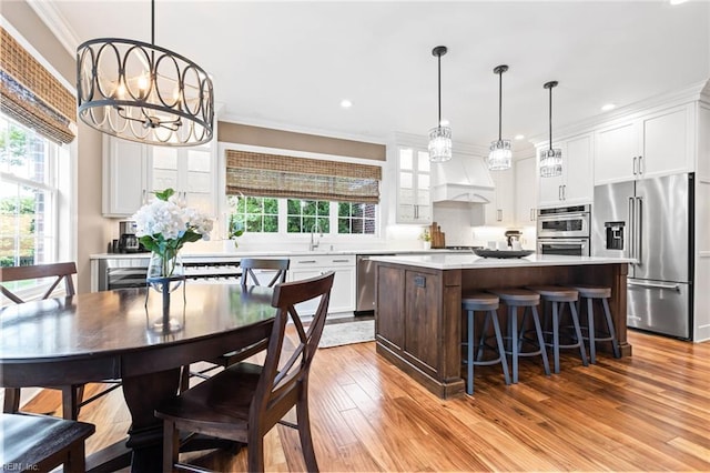1704 Lower Church Ct, Virginia Beach, VA 23455 - kitchen featuring appliances with stainless steel finishes, a center island, light countertops, white cabinets, and wood finished floors