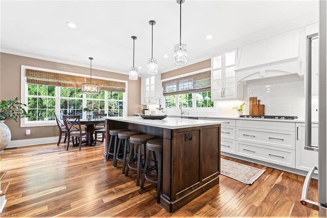 1704 Lower Church Ct, Virginia Beach, VA 23455 - kitchen featuring a chandelier, white cabinets, light countertops, glass insert cabinets, and a kitchen island