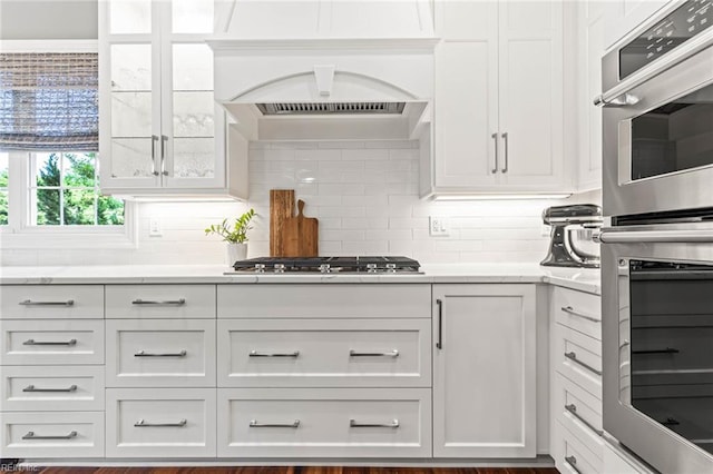 1704 Lower Church Ct, Virginia Beach, VA 23455 - kitchen featuring appliances with stainless steel finishes, white cabinets, backsplash, and light stone counters