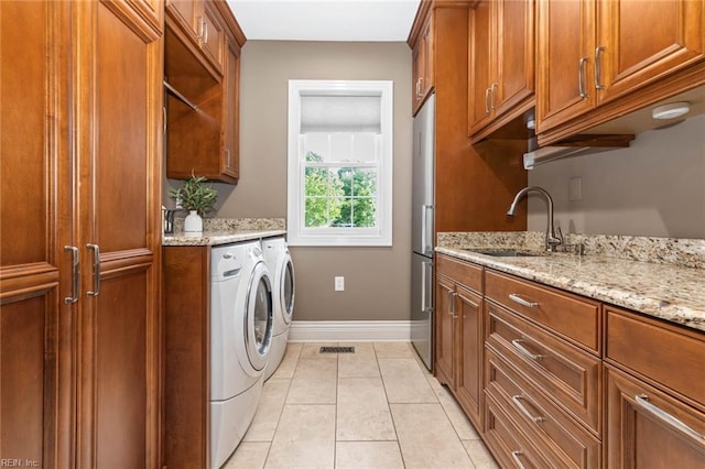 1704 Lower Church Ct, Virginia Beach, VA 23455 - laundry room featuring cabinet space, independent washer and dryer, light tile patterned floors, and baseboards