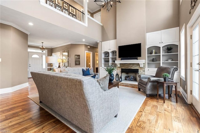 1704 Lower Church Ct, Virginia Beach, VA 23455 - living area featuring a chandelier, a high ceiling, baseboards, crown molding, and light wood-style flooring