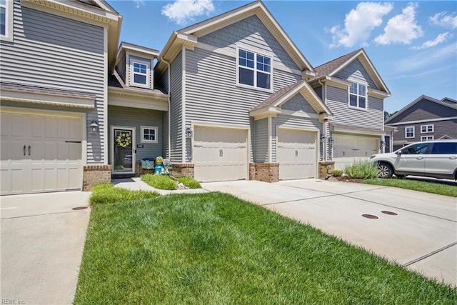 view of front of house featuring concrete driveway, a garage, brick siding, and a front lawn