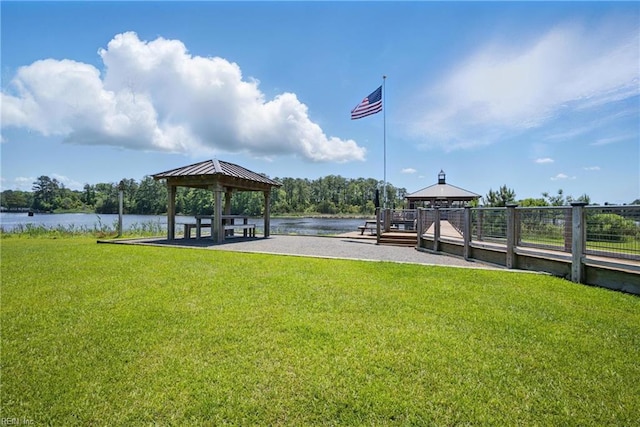 view of community with a gazebo, a yard, and a water view