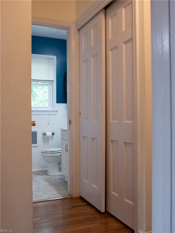 830 Burton St, Hampton, VA 23666 - corridor with wood finished floors and tile walls