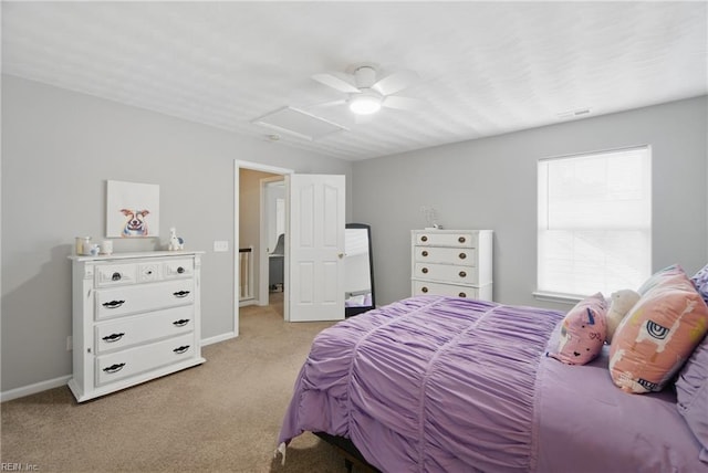 bedroom featuring attic access, light colored carpet, baseboards, and a ceiling fan