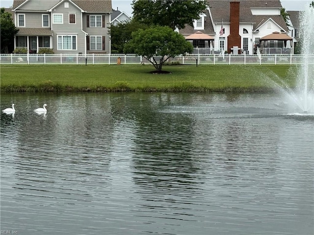 water view with fence and a gazebo