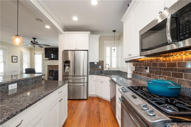 9517 24th Bay St, Norfolk, VA 23518 - kitchen with appliances with stainless steel finishes, a sink, healthy amount of natural light, white cabinetry, and ornamental molding